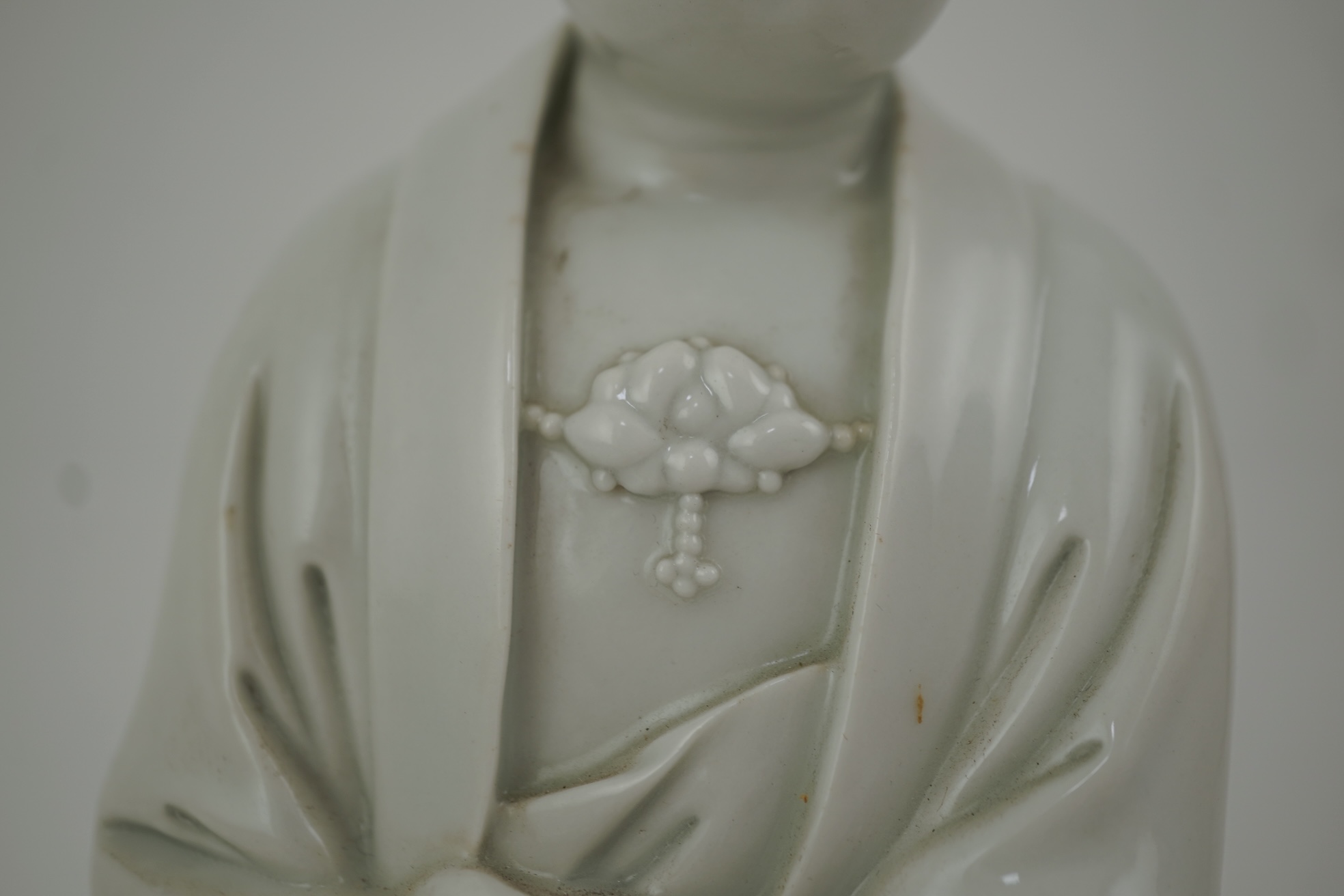 A Chinese blanc-de-chine seated figure of Guanyin, late 19th/early 20th century